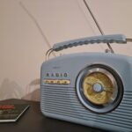 a radio sitting on top of a table next to a book